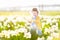 Funny toddler girl field of white daffodil flowers