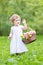 Funny toddler girl playing with a flower basket