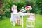 Funny toddler girl playing tea party with a doll