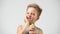 Funny toothless boy with sensitive teeth holding ice cream