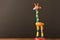 Funny toy giraffe on the wooden table. Empty text space