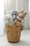 Funny toys in basket on floor. Decor for children`s room