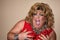 Funny travesty actor. Drag queen in red