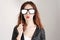 Funny trendy fashion girl with paper glasses playing with emotion