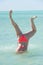 Funny underwater handstand bikini woman
