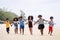 Funny vacation. Children or kids playing and romp together at the beach on holiday. Having fun after unlocking down the city from