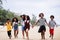 Funny vacation. Children or kids playing and romp together at the beach on holiday. Having fun after unlocking down the city from