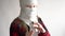 Funny video - quarantined due to an epidemic of coronavirus. girl in a mask from toilet paper posing on a gray