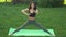 Funny video about young woman doing yoga exercise and fooling around outdoors in park at morning.