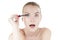 Funny woman applying cosmetics mascara brush.