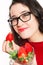Funny woman with eyeglasses eating strawberries