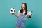 Funny woman football fan cheer up support favorite team with soccer ball, Earth world globe isolated on blue turquoise