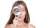 Funny woman looking through magnifying glass