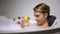 Funny woman shouting to rubber duck during bathing with bubbles, childish mood