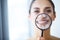 Funny woman smiling and show teeth through a magnifying glass