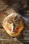 Funny wooden mask for decorating house in Zermatt village