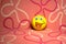 Funny yellow emoticon smiley rubber children ball on pink felt background