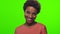 Funny young African American woman with glad expression, blinks eye, flirts