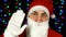 Funny young man in a suit of Santa Claus, waving his hand