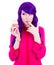 funny young woman with purple hair holding cupcake with pink cream isolated on white