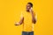 Furious African American Man Talking On Phone Over Yellow Background