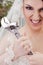 Furious bride holding wrench