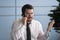 Furious businessman talks on phone solves business issues with client