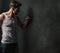 Furious young man punching the concrete wall