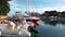 FURNARI, SICILY, ITALY - SEPT, 2019: Tiled walkway at dock with moored sailing yachts and runabouts