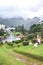 Furnas, Azores, Portugal - Jan 13, 2020: Volcanic hot springs in Portuguese Furnas. Steam coming from the water pools. Houses and
