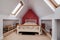 Furnished attic style bedroom with open storage