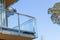 Furnished balcony of the house in the forest on the background of blue sky