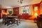 Furnished dining room with red wallpaper