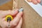 Furniture assembler fixes cam lock nut in furniture.