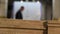 Furniture board close-up, worker in the background. Flat wooden sheet, Torces furniture board