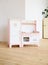 Furniture for children. Sweet little pink kitchen with fridge, stove, oven and sink in light room