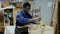 furniture restorer renewing vintage chest of drawers in workshop