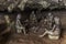 FURONG ZHEN, CHINA - AUGUST 11, 2018: Sculptures of prehistoric people in a cave under the waterfall in Furong Zhen town