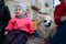 Furry dog on a bench with people