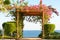 Fuschia Flowers Climbing a Wooden Trellis Archway Facing the Oce