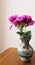 Fushia Iris blooms in small horse-hair  pottery vase