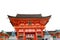 Fushimi Inari Taisha shrine and dog statue in front of entrance or access with sky background. Ancient castle or Japanese temple.