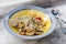 Fusilli Avellinesi pasta with clams and tomato in yellow and blue plate