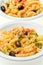 Fusilli with cheese, fresh tomatoes and olives.