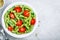 Fusilli pasta with basil pesto sauce , tomatoes and pine nuts