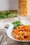 Fusilli pasta bolognese sprinkled with cheese