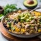 Fusilli pasta salad with black beans, avocado, corn and chicken.