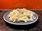 fusilli pasta with white cream sauce with mushrooms and bacon