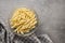 Fusilli pugliesi. Italian twisted pasta in bowl on gray table. Top view