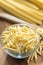 Fusilli pugliesi. Italian twisted pasta in bowl on wooden table